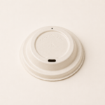 Compostable bagasse cup lids providing a secure fit for hot beverage takeaway cups.